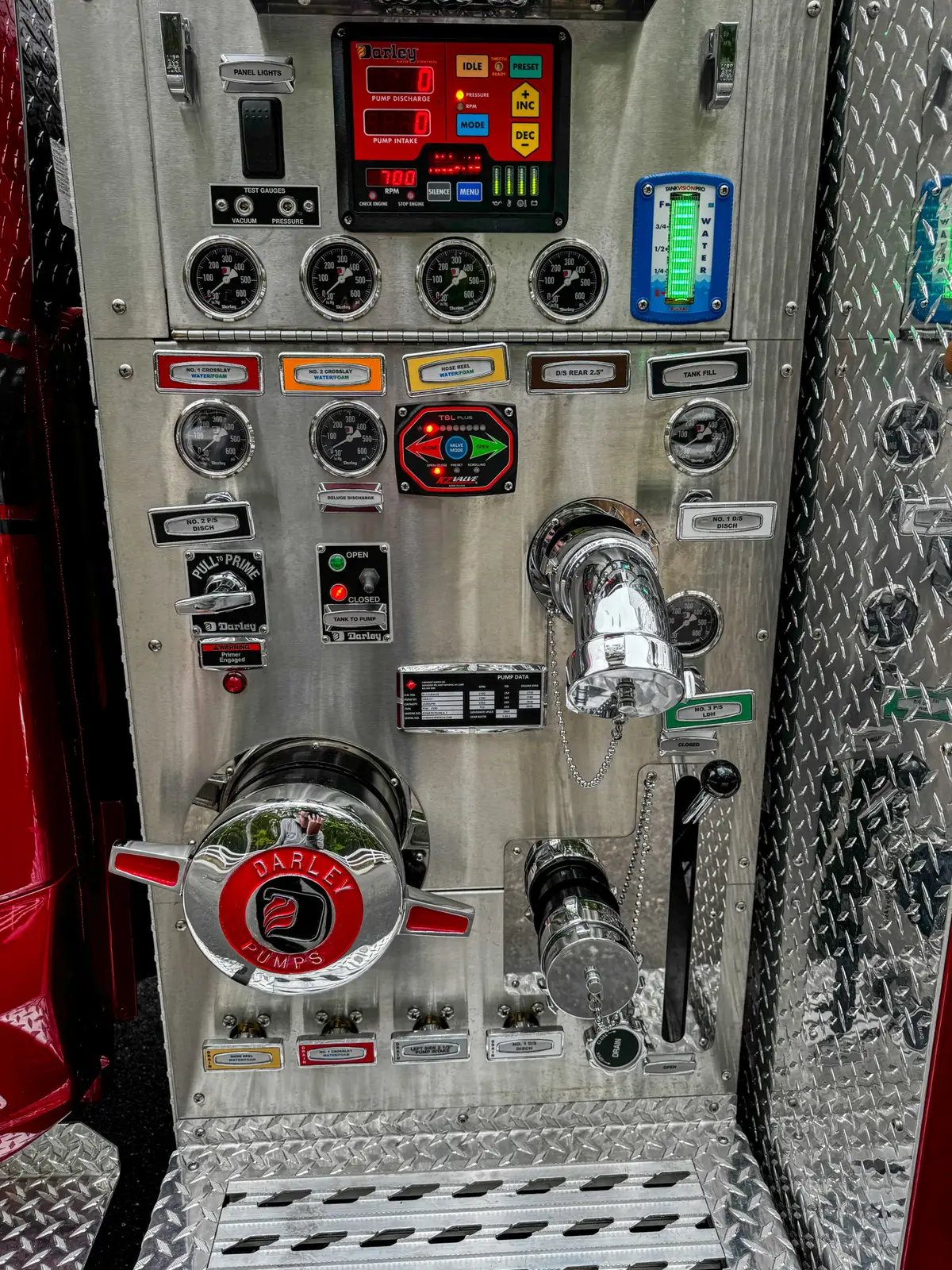 Pump panel detail showing intake/discharge hardware and control labels.